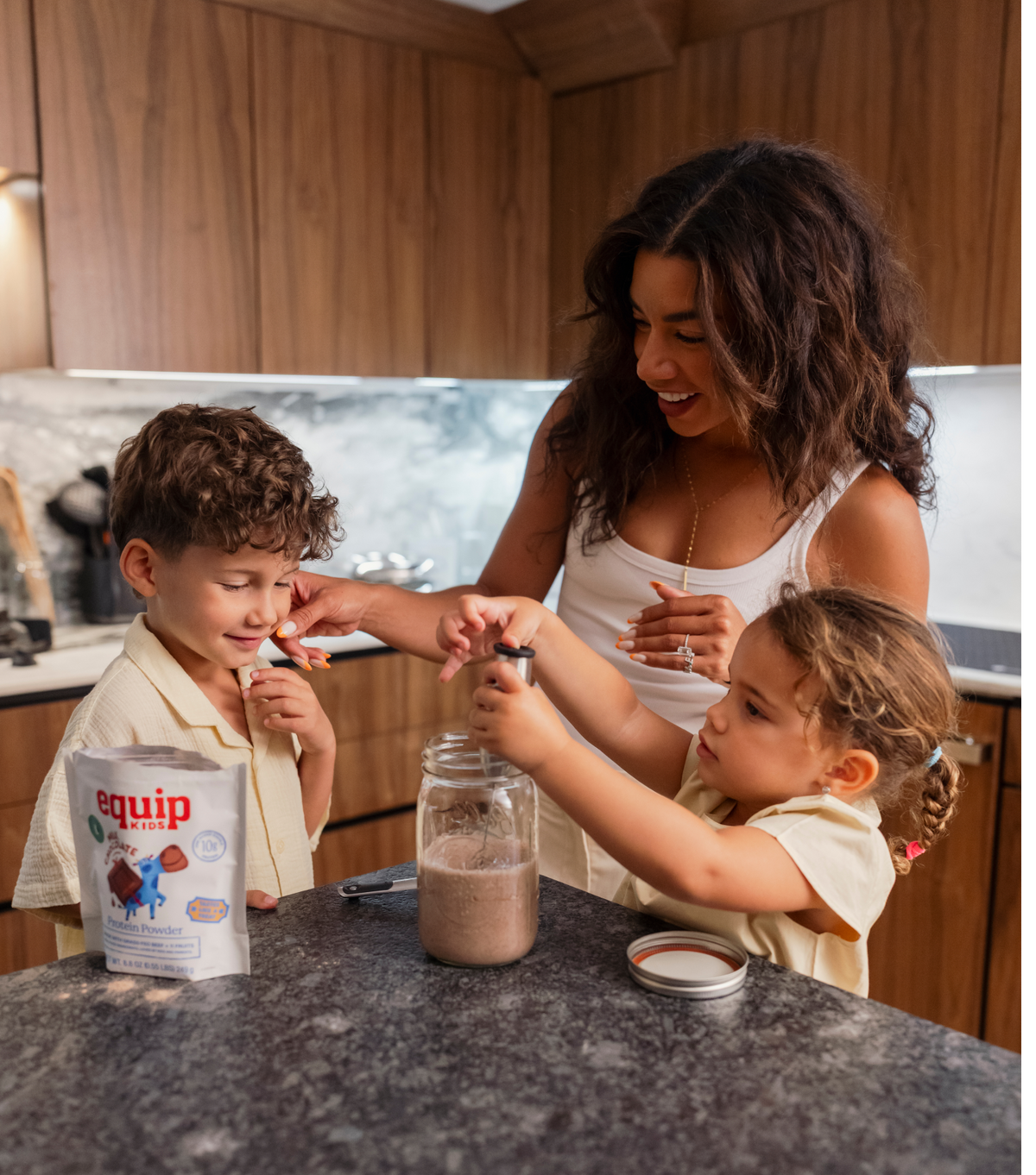 Two kids sharing an Equip Kids bar in a kitchen