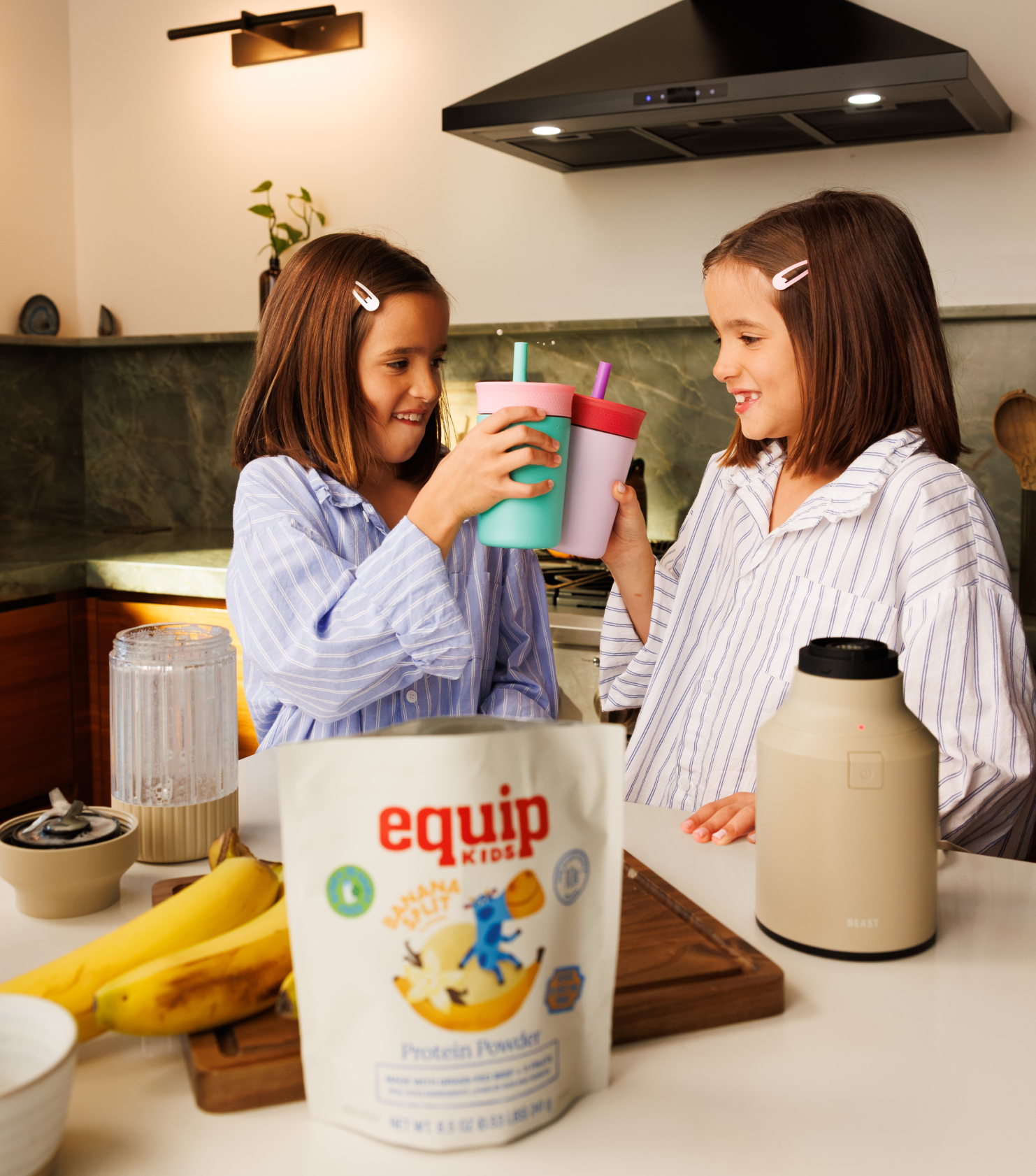 Two kids sharing an Equip Kids bar in a kitchen