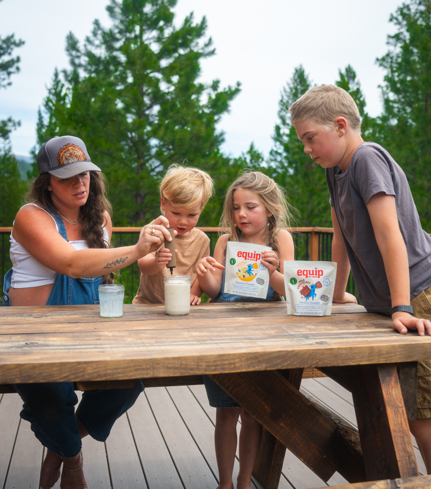 Two kids sharing an Equip Kids bar in a kitchen