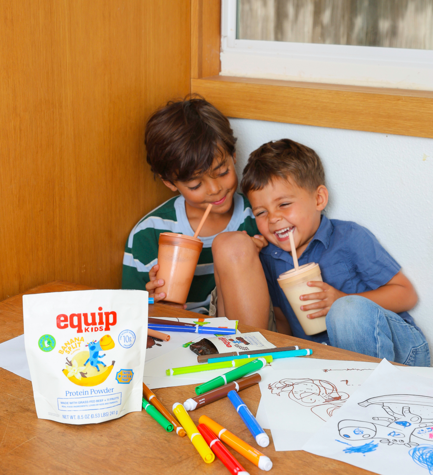Two kids sharing an Equip Kids bar in a kitchen